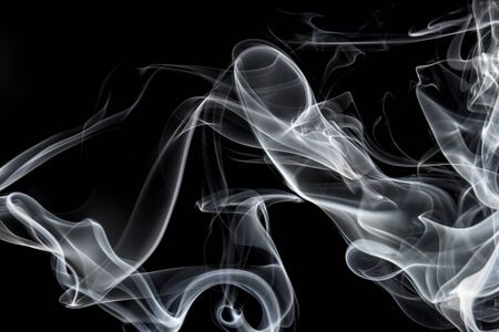 White smoke on black background, movement of white smokeの写真素材
