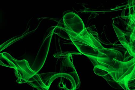 Green smoke on black background, movement of white smokeの写真素材