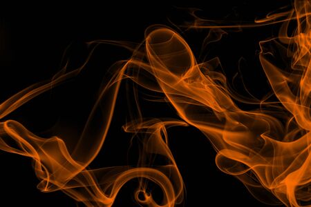 Orange smoke on black background, movement of white smokeの写真素材