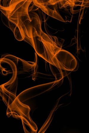 Orange smoke on black background, movement of white smokeの写真素材