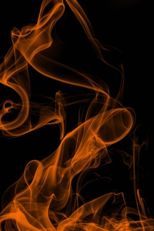 Orange smoke on black background, movement of white smokeの写真素材