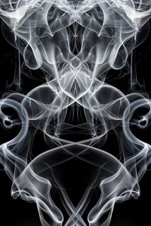White smoke on black background, movement of white smokeの写真素材