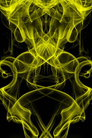 Yellow smoke on black background, movement of white smokeの写真素材