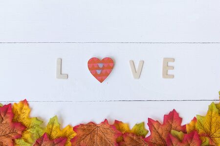 Love day concept. The wooden text remain to valentine's day with maple leaf and white background.valentine day, february14の写真素材