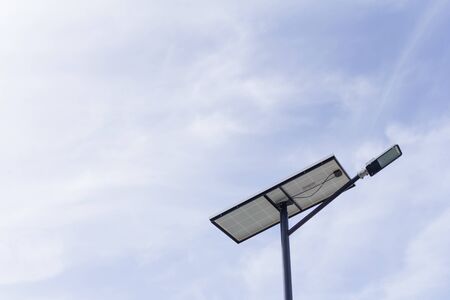 The lamp post and photovoltaic panel with blue sky backgroundの写真素材