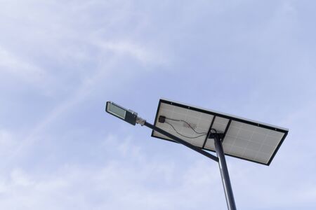 The lamp post and photovoltaic panel with blue sky backgroundの写真素材