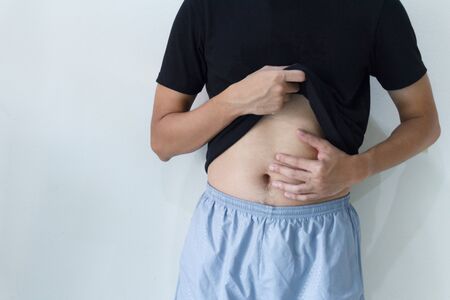 Young asia man is having stomach ache.の写真素材