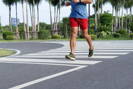 Close up of sport man running in the morning. workout concept.の写真素材