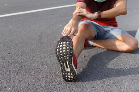 Sport man in medical protective mask. He warm up before running. exercise concept. Warm up concept....