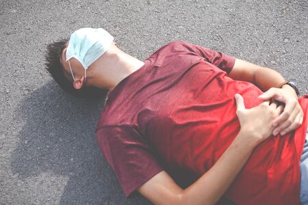 The man is tired from a workout rest. side cramps after running. workout conceptの写真素材