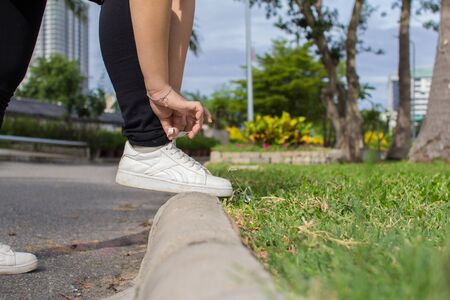 Close-up of sportgirl tying sneakers on running shoes