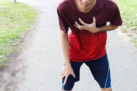 Sport man suffering from chest pain heart attack after running. 