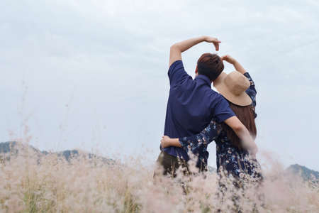 Couple love in a blue dress on a wheat field. woman in meadow concept , valentineの写真素材