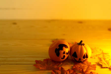Halloween pumpkins with painted faces on a wooden table. Halloween background. Space for text. copy space. Halloween conceptの写真素材