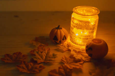 Halloween pumpkins with painted faces on a wooden table. Halloween background. Space for text. copy space. Halloween conceptの写真素材