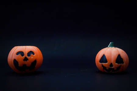 Halloween pumpkins on the black paper background. Halloween background. Space for text. copy space.の写真素材