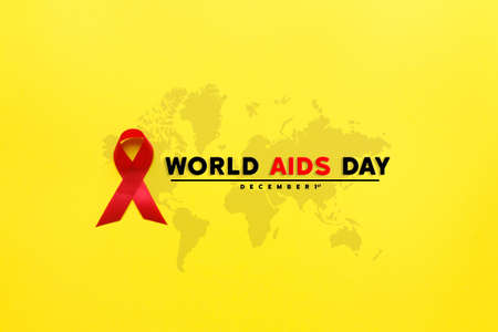red AIDS awareness ribbon on yellow paper background. World aids day and healthcare and medicine...