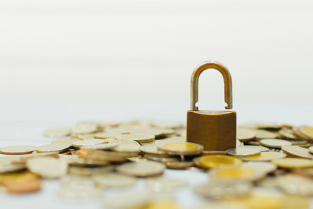Coin money and lock on whiteの写真素材