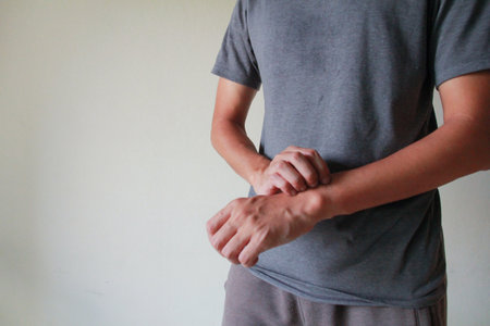 Closeup of male arms holding his painful wrist