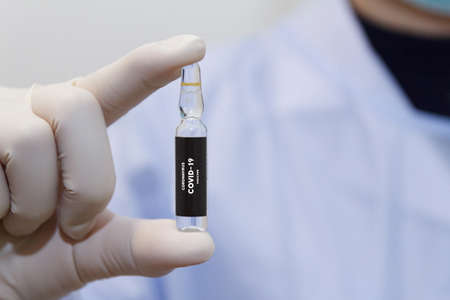 Doctor's hand holding bottle vaccine , Medication treatment concept.の写真素材