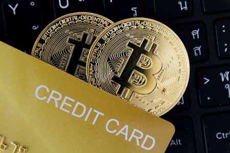 bitcoin and credit card are place on the keyboard of the laptop  cryptocurrency trading technology...