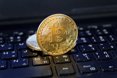 bitcoin is place on the keyboard of the laptop, cryptocurrency trading technology concept.