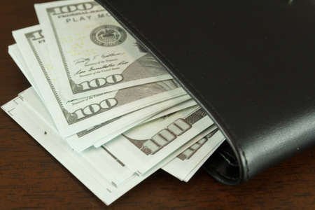 Mock up cash in the black wallet.