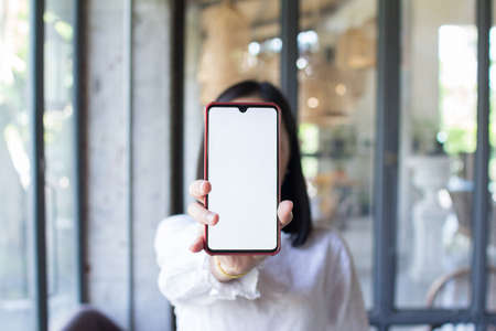 Close up of woman hand showing blank phone screen. Concept of technology communication.