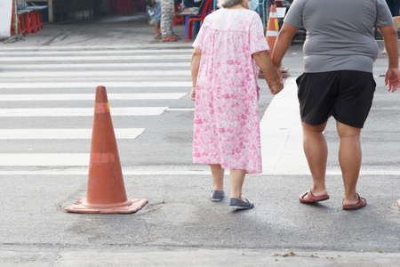 The Son who helps his mother crosses the road.の写真素材