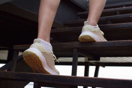 closeup of female walk up on staircase.  step walkの写真素材