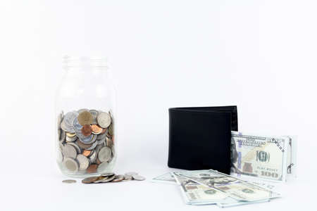 Coin in bottle and mock up cash with white background.の写真素材