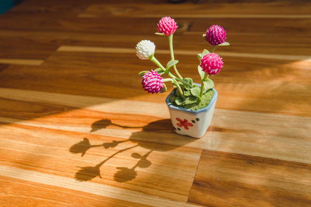 flowers in a vase on wooden tableの写真素材