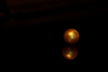 golden south sea pearl on black backgroundの写真素材