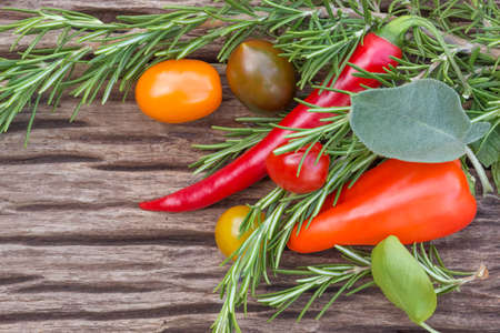 fresh herbs and organic vegetables on  wooden backgroundの写真素材