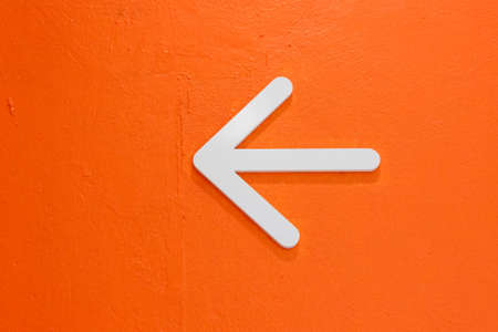 White Arrow on Orange Wallの写真素材