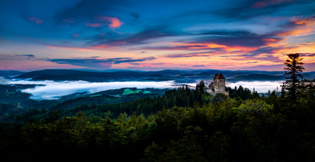 Sunset in Kasperk castle, Sumava, Czech Republic. Cold day in Sumava National park, hills and villages in the fog, misty view on Czech landscape, evening scene.のeditorial素材