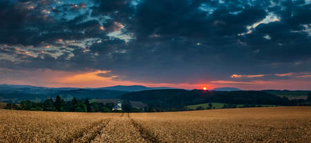 sunrise over the village of Mricna Krkonose mountains from a field with grain, the best photoの写真素材