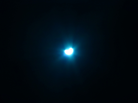 Bright blue crescent surrounded by the darknessの写真素材