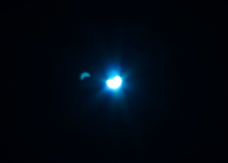 Eclipsed Sun through a blue filterの写真素材