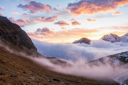 Great view of the foggy valley in Gran Paradiso National Park,  Alps, Italy,  dramatic scene,...