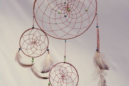 Detail of the indian dream catcher, three circles, beads and plumageの写真素材