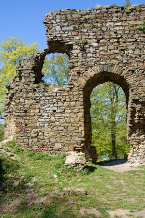 Ruins of the stone mediaval castle, walls, treesの写真素材