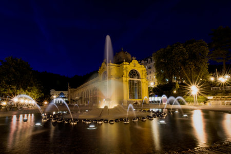 Main colonnade in the small west Bohemian spa town Marianske Lazne and singing fountain at night - Czech Republicのeditorial素材