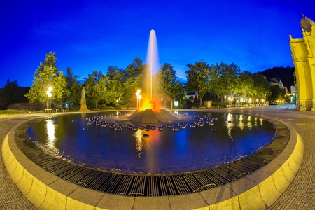 Main colonnade in the small west Bohemian spa town Marianske Lazne and singing fountain at night - Czech Republicの写真素材