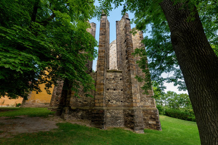 The unbuilt Monastery Church of the Virgin Mary is an unfinished Gothic building with a completed Baroque bell tower in Panensky Tynecのeditorial素材