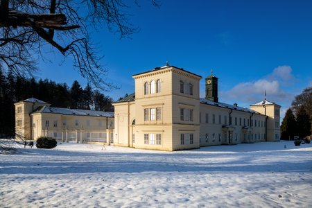Lazne Kynzvart, Czech Republic - January 23, 2023: State Classicist chateau Kynzvart in winter under snow and with blue sky - castle is located near famous spa town Marianske Lazneのeditorial素材
