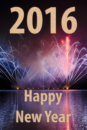Wishes for the new year 2016 with fireworks in purple shades on the surface of the damの写真素材