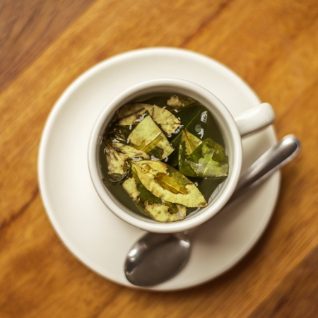 Cup of Coca Tea on Wooden table with Diagonal Linesの写真素材