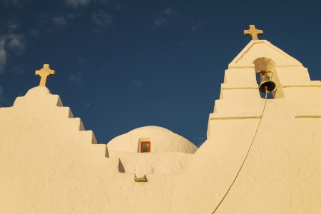 View from bellow to church in Mykonos, Greece  Beautiful yellow color on the church is in contrast to rich blue sky の写真素材