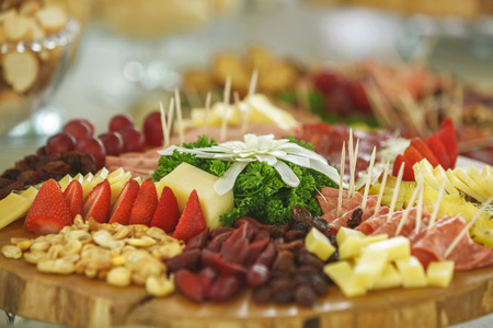Catering service with various fruits and vegetables on wooden plateの写真素材